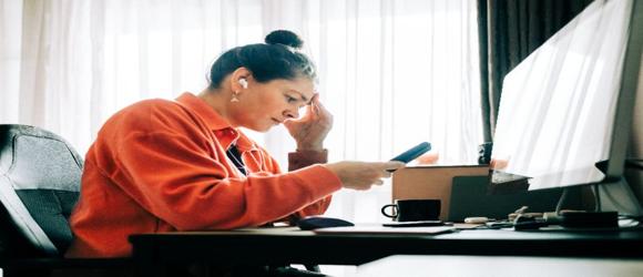 person using phone at desk
