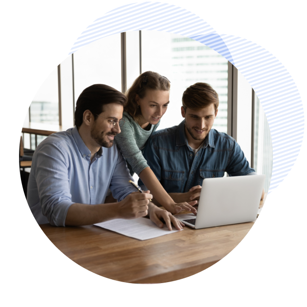three people gathered around a laptop