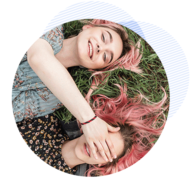 women laying in the grass